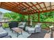 Inviting covered deck with a ceiling fan and comfortable seating, perfect for outdoor relaxation at 545 Ashvale Overlook, Alpharetta, GA 30005