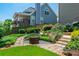 Scenic backyard with stone pathway, garden bench, tiered flower beds and stone staircase at 545 Ashvale Overlook, Alpharetta, GA 30005