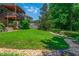 Expansive backyard featuring a lush lawn, rock border, and mature trees for added privacy at 545 Ashvale Overlook, Alpharetta, GA 30005