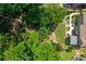 Aerial view of landscaped backyard, fire pit area, stone walkway, and surrounding trees at 545 Ashvale Overlook, Alpharetta, GA 30005