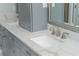 Bathroom with a double vanity, white marble counters, and modern fixtures at 545 Ashvale Overlook, Alpharetta, GA 30005