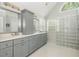Bright bathroom with a double vanity, large mirror, and modern lighting fixtures at 545 Ashvale Overlook, Alpharetta, GA 30005