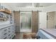 Spacious bedroom with sliding barn doors leading to a bathroom, enhancing privacy and style at 545 Ashvale Overlook, Alpharetta, GA 30005