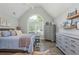 Bright bedroom features a large window, light gray walls, and wood-look floors at 545 Ashvale Overlook, Alpharetta, GA 30005