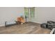 Empty bedroom with hardwood floors and large window at 545 Ashvale Overlook, Alpharetta, GA 30005