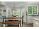 Dining area with a wooden table, a large window, and view of the backyard at 545 Ashvale Overlook, Alpharetta, GA 30005