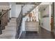 Inviting foyer featuring stairs and decorative accents, with a stylish chest at 545 Ashvale Overlook, Alpharetta, GA 30005