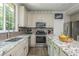 Well-lit kitchen with granite countertops, stainless appliances, and ample counter space at 545 Ashvale Overlook, Alpharetta, GA 30005