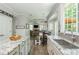 Well-lit open floor plan with an island kitchen, dining area, and view to the living room at 545 Ashvale Overlook, Alpharetta, GA 30005