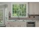 Bright kitchen counter with granite countertop and sink under a window with a view at 545 Ashvale Overlook, Alpharetta, GA 30005