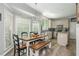 Eat-in kitchen featuring stainless appliances, bright lighting, and a rustic wooden dining table with bench seating at 545 Ashvale Overlook, Alpharetta, GA 30005