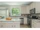 Cozy kitchen featuring granite countertops, stainless appliances and view to the backyard at 545 Ashvale Overlook, Alpharetta, GA 30005
