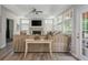 Spacious living room with many windows, a fireplace, and access to the patio or outdoor area at 545 Ashvale Overlook, Alpharetta, GA 30005