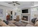 Cozy living room features a fireplace, a large TV, and a comfortable seating arrangement at 545 Ashvale Overlook, Alpharetta, GA 30005