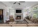 Bright living room with a fireplace, multiple windows, and a comfortable seating area at 545 Ashvale Overlook, Alpharetta, GA 30005