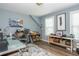 Bright home office with natural light, built-in shelves, and hardwood floors, ideal for productivity at 545 Ashvale Overlook, Alpharetta, GA 30005