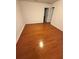 Empty bedroom featuring gleaming hardwood floors, neutral walls, and bright white doors at 1392 Weatherbrook Cir, Lawrenceville, GA 30043