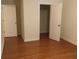 Bedroom featuring gleaming hardwood floors, neutral walls, a closet, and bright white doors at 1392 Weatherbrook Cir, Lawrenceville, GA 30043