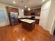 A modern kitchen with stainless steel appliances, an island, and ample wood cabinets at 1392 Weatherbrook Cir, Lawrenceville, GA 30043