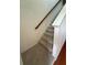 Carpeted staircase featuring hardwood banister at 1392 Weatherbrook Cir, Lawrenceville, GA 30043