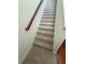 Carpeted stairs with a wood handrail offer a safe and stylish transition between floors at 1392 Weatherbrook Cir, Lawrenceville, GA 30043