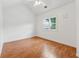 Bedroom with wood-look floors, a vaulted ceiling with fan, and a bright window at 3665 Magnolia Walk Trl, Cumming, GA 30040