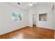 Bedroom featuring wood-look floors, a vaulted ceiling, a window, and a view into the closet at 3665 Magnolia Walk Trl, Cumming, GA 30040