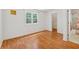 Bright bedroom features wood floors, large window, and access to a walk-in closet and full bathroom at 3665 Magnolia Walk Trl, Cumming, GA 30040