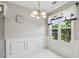 Dining room featuring wainscotting, a modern chandelier and large window at 3665 Magnolia Walk Trl, Cumming, GA 30040