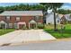 View of attractive brick townhome with large driveway and well-maintained landscaping at 3665 Magnolia Walk Trl, Cumming, GA 30040