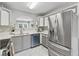 Updated kitchen featuring stainless steel appliances and sleek gray and white cabinetry at 3665 Magnolia Walk Trl, Cumming, GA 30040