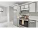 Bright kitchen showcasing updated appliances and stylish gray and white cabinets at 3665 Magnolia Walk Trl, Cumming, GA 30040