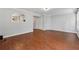 Open-concept living room with hardwood floors and view into the bright kitchen at 3665 Magnolia Walk Trl, Cumming, GA 30040