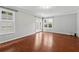 Living room with hardwood floors, and natural lighting from the large window and french doors at 3665 Magnolia Walk Trl, Cumming, GA 30040