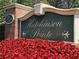 Hutchinson Pointe community entrance sign with flowers at 3665 Magnolia Walk Trl, Cumming, GA 30040