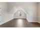 Cozy attic area with wood flooring and a window at 1496 Clarecastle Ln, Buford, GA 30519
