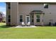 Backyard with a well-maintained lawn and patio seating, perfect for outdoor enjoyment at 1496 Clarecastle Ln, Buford, GA 30519