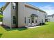 Wide backyard with a neutral-tone exterior, lawn, and patio seating for relaxing outdoors at 1496 Clarecastle Ln, Buford, GA 30519