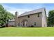 Large backyard with a patio and seating area ideal for outdoor entertaining and relaxation at 1496 Clarecastle Ln, Buford, GA 30519