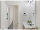 Bright bathroom with a single sink vanity and an open doorway to the hallway at 1496 Clarecastle Ln, Buford, GA 30519