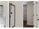 Bathroom featuring a glass shower, dark hardware, and a doorway to a walk-in closet at 1496 Clarecastle Ln, Buford, GA 30519