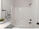 Clean bathroom featuring tub and shower with modern fixtures at 1496 Clarecastle Ln, Buford, GA 30519