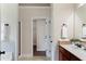 Bathroom with a single sink vanity, a shower and an open door leading to the walk-in closet at 1496 Clarecastle Ln, Buford, GA 30519
