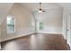 Spacious bedroom with plenty of natural light from the windows and wood flooring at 1496 Clarecastle Ln, Buford, GA 30519