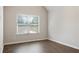 Bedroom with vaulted ceiling, hardwood floors, and window with blinds at 1496 Clarecastle Ln, Buford, GA 30519