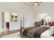 Large bedroom with hardwood flooring, furnished with a rug, bed, desk, and seating at 1496 Clarecastle Ln, Buford, GA 30519