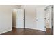 This bedroom features multiple doors and hardwood floors at 1496 Clarecastle Ln, Buford, GA 30519