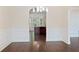Open dining room with hardwood floors, arched doorway, and view of the kitchen, offering a spacious feel at 1496 Clarecastle Ln, Buford, GA 30519