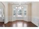 Elegant dining room with hardwood floors, wainscoting, and a modern chandelier, perfect for entertaining at 1496 Clarecastle Ln, Buford, GA 30519