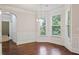 Bright dining area with hardwood floors, wainscoting, and large windows at 1496 Clarecastle Ln, Buford, GA 30519